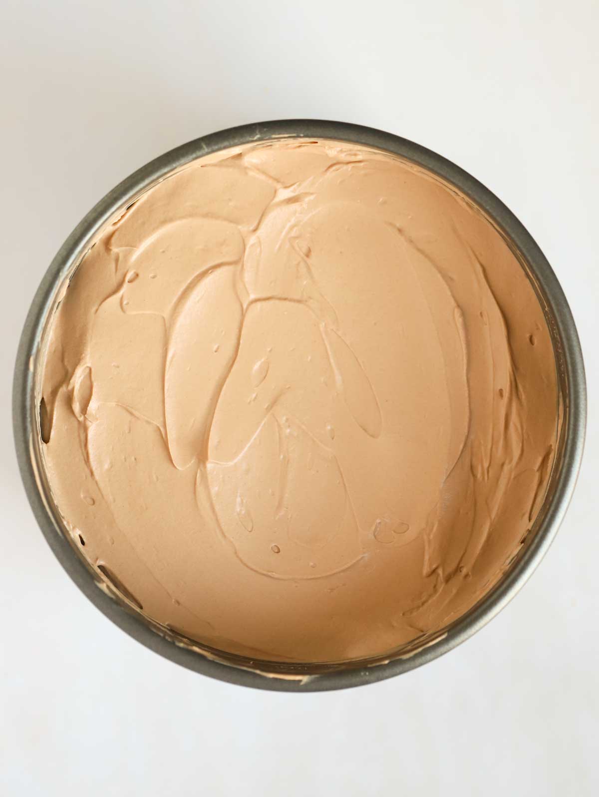 Whipped cream in a baking tin for for step 4 in the recipe for Nutella Cheesecake.