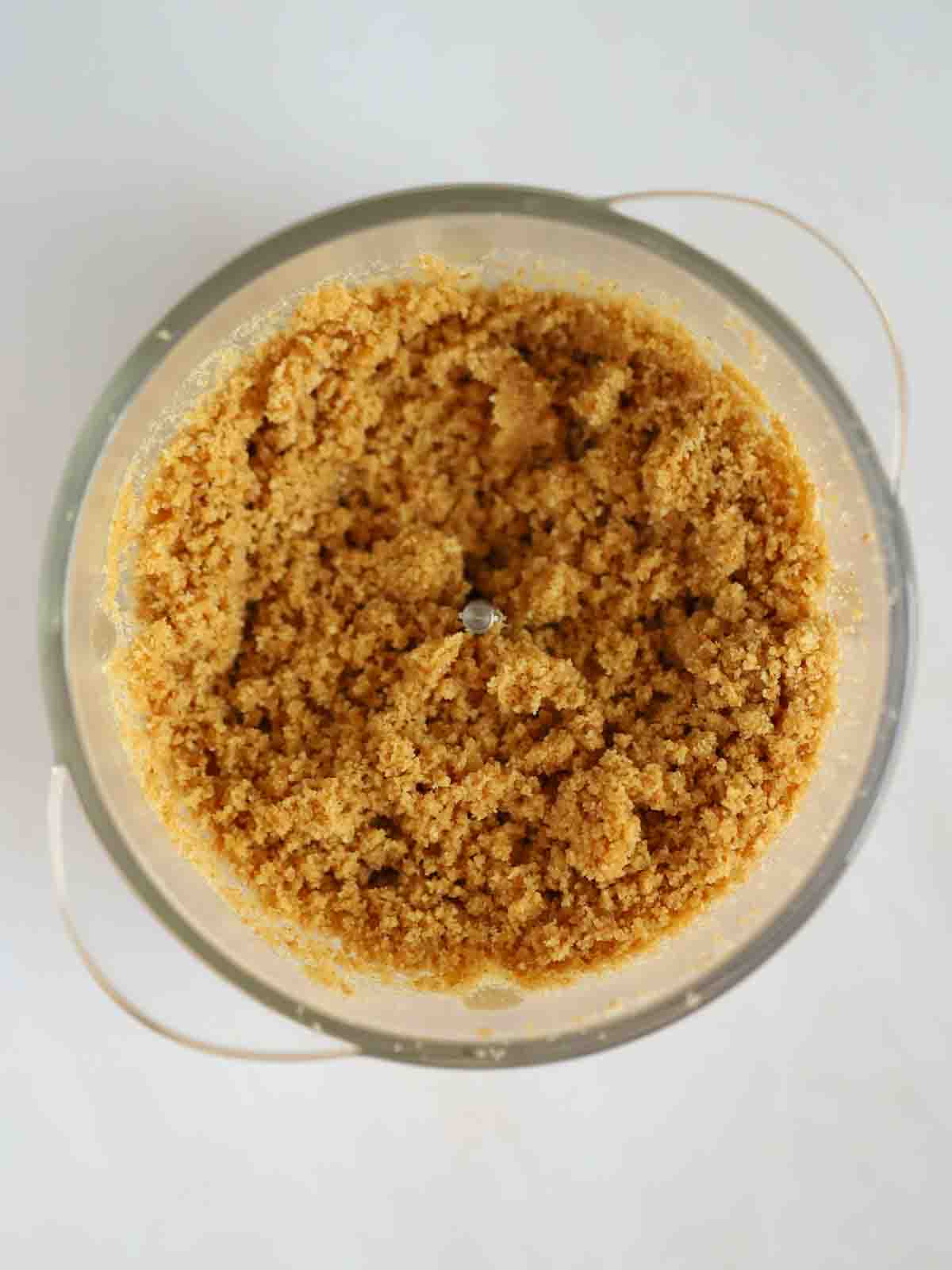 Biscuits crushed in a food processor for step 1 in the recipe for Strawberry Cheesecake.