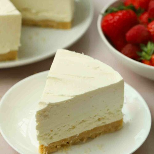 A slice of vanilla cheesecake, ready to eat with a fork.