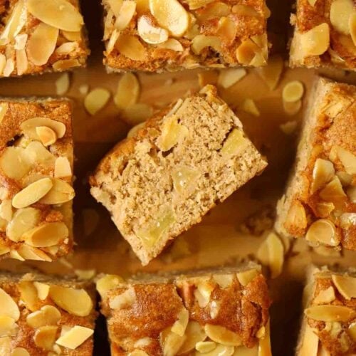 Apple cake squares on a wooden board.