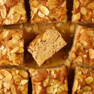 Squares of cooked apple cake with nutty topping.