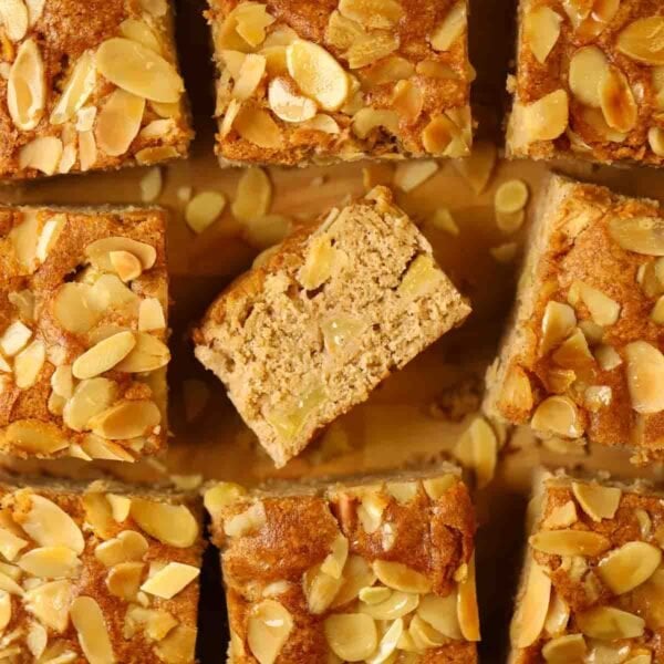 Squares of cooked apple cake with nutty topping.
