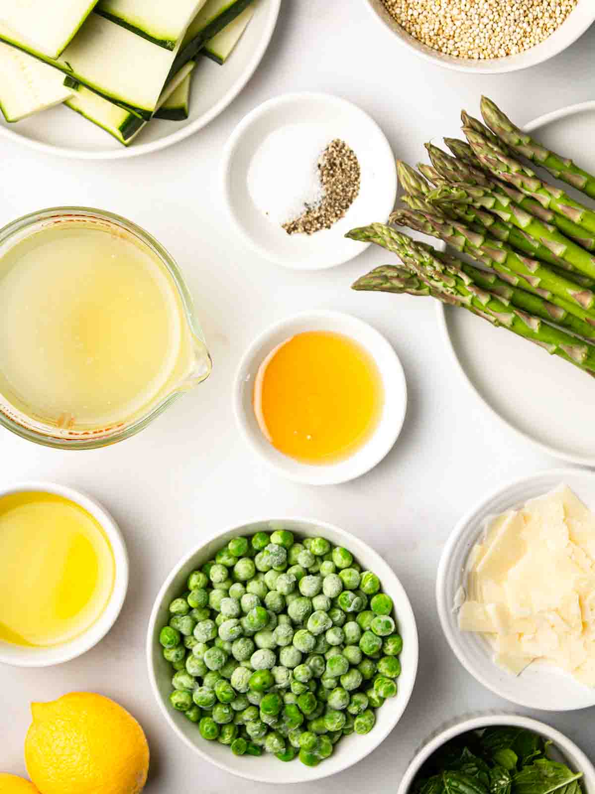 Small bowls of ingredients for a Quinoa Salad laid out on a counter top.