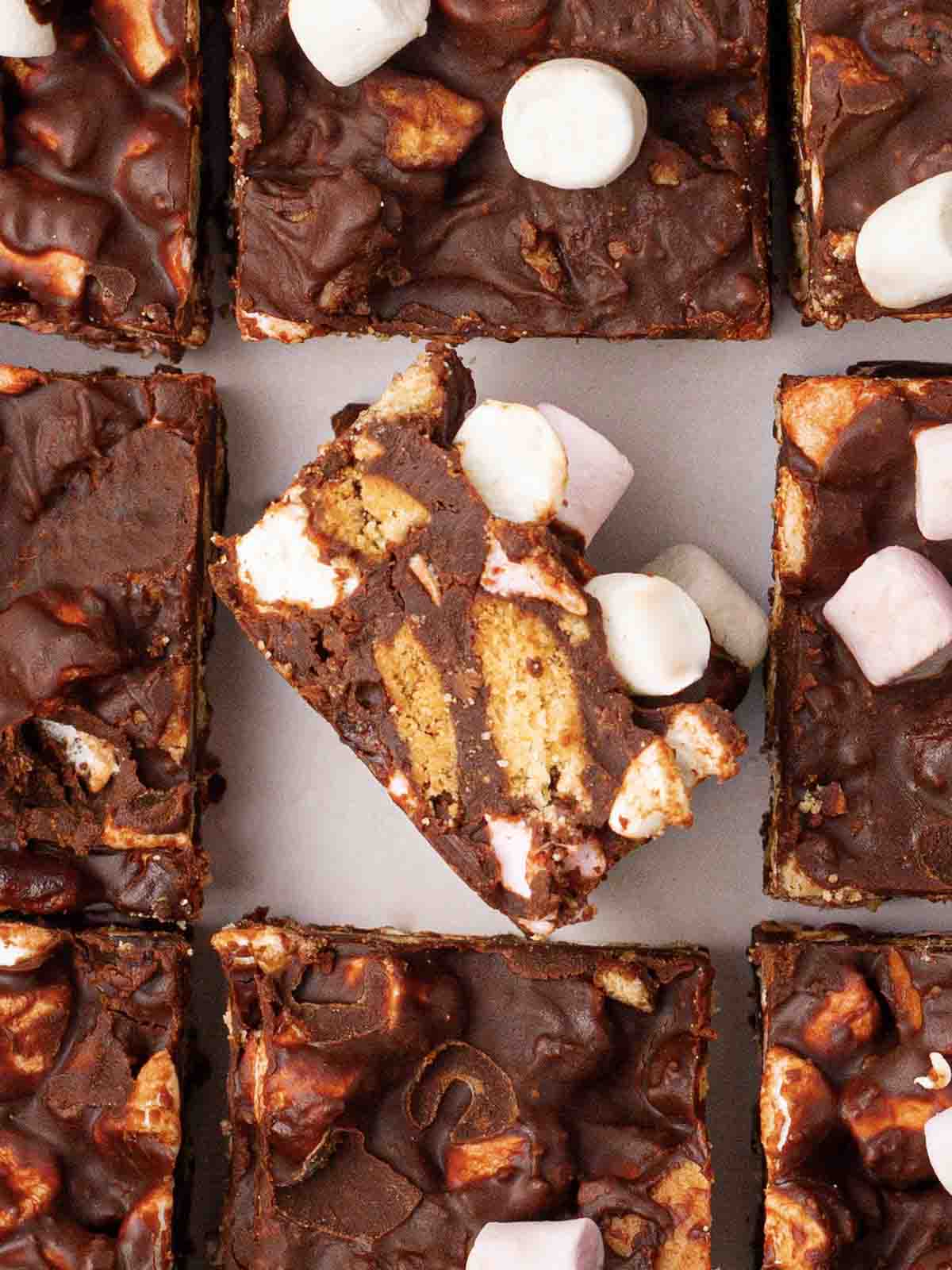 Squares of rocky road with one in the middle on its side, showing the inside.