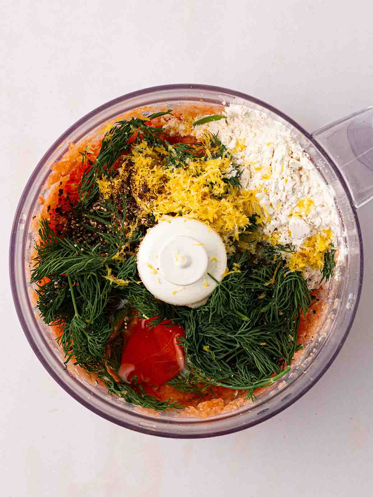 A blender with the ingredients for Salmon Burgers inside.