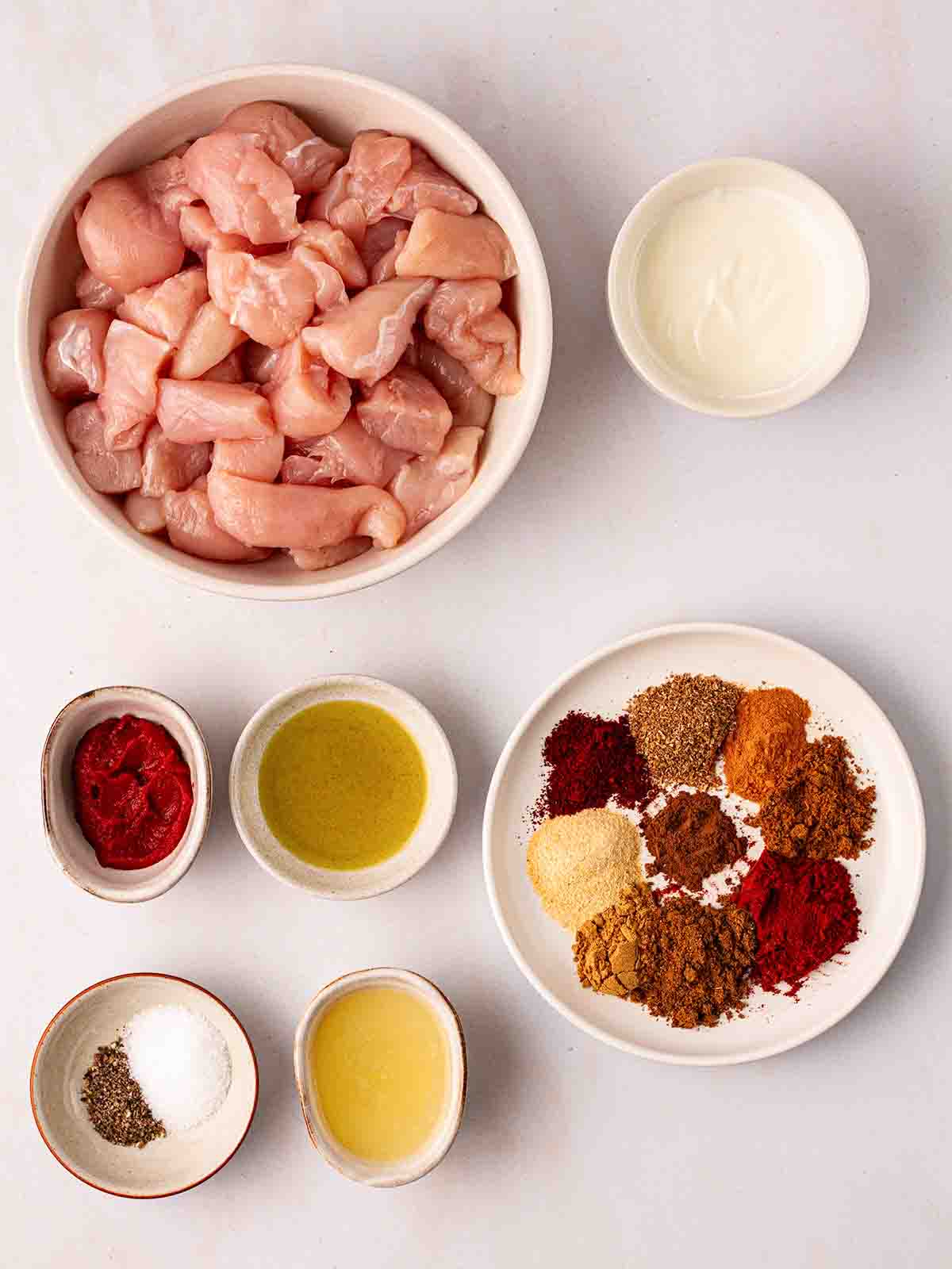 The ingredients for Tandoori Chicken skewers laid out on a counter top.