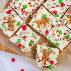 White chocolate Christmas Rocky Road squares topped with gingerbread men, candy canes and red and green skittles.