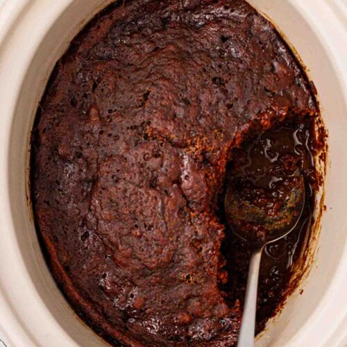 A slow cooker filled with sticky toffee pudding.