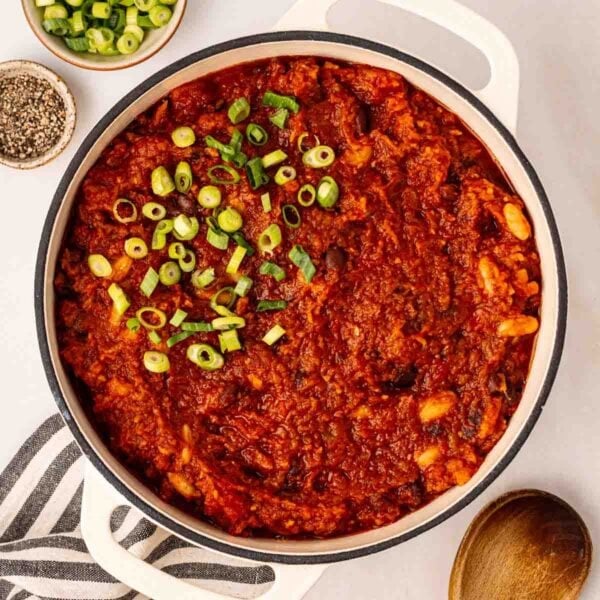 A big pan of Vegan Chilli with spring onions on top, ready to serve.