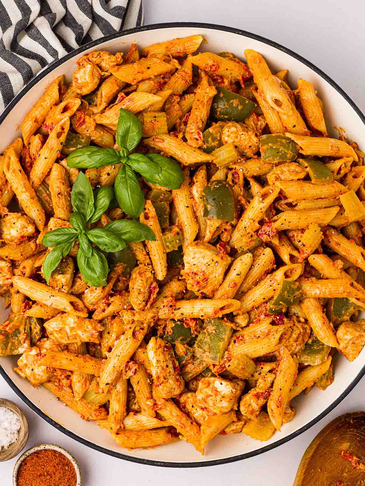 A big bowl of Cajun Chicken Pasta with basil on top.