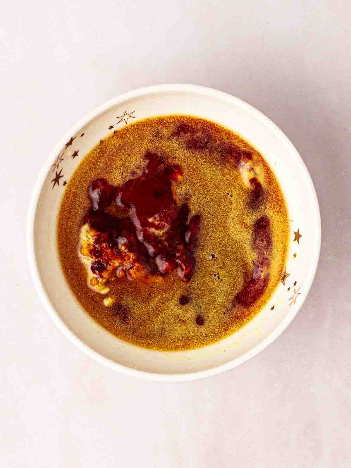 A bowl of BBQ sauce ingredients to be mixed to add to slow cooker beef brisket.