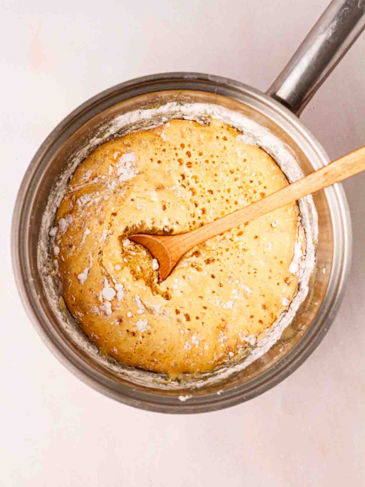 Honeycomb mixture bubbling in a pan for step 4 in the recipe process.