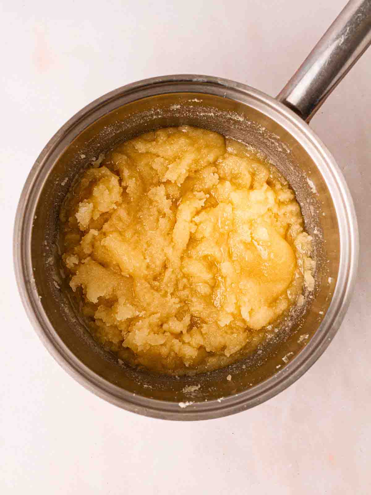 A honeycomb mixture in a pan before it bubbles and sets.