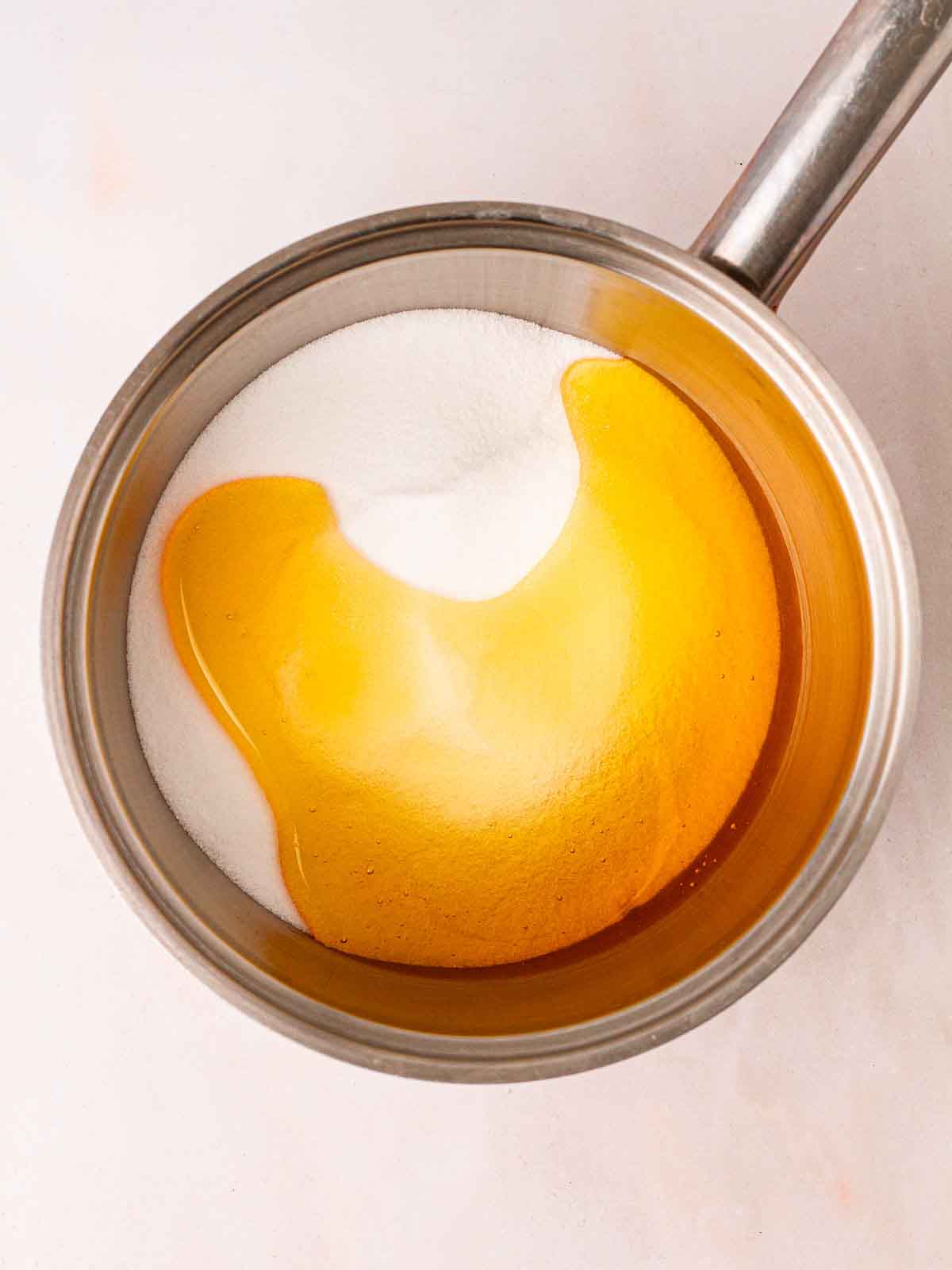 Golden syrup and caster sugar in a pan.