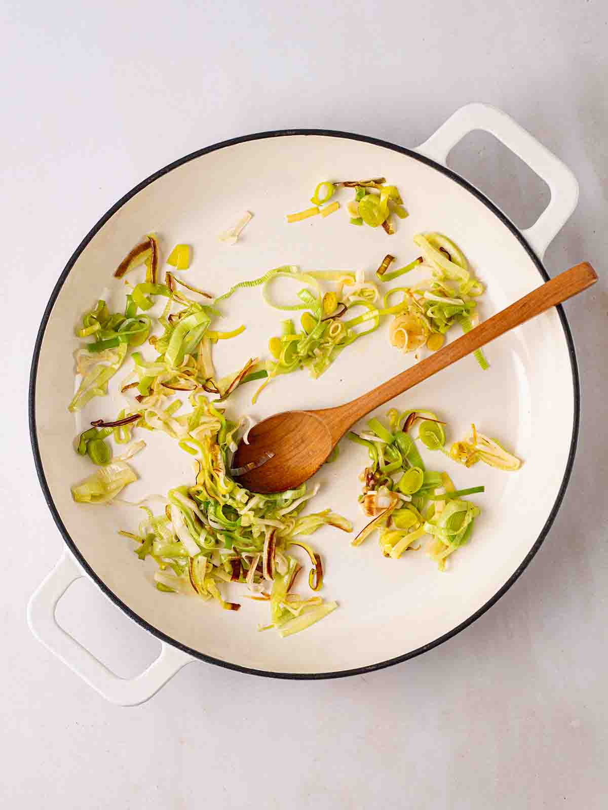 Leeks cooking in a pan for step 1 in the recipe for Smoked Haddock Risotto.