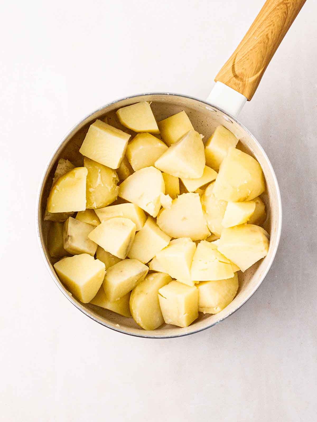 A pan filled with white potato cubes.