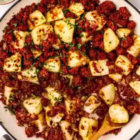A close up of a plate of Corned Beef Hash, with cubed potatoes and tinned corned beef hash.