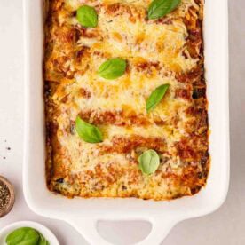 A baked Spinach and Ricotta Cannelloni in a white oven dish, ready to eat.