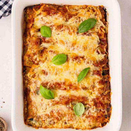 A just-baked Spinach and Ricotta Cannelloni in a white dish, ready to be served.