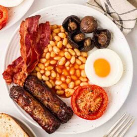 A plate of cooked Full English Breakfast, ready to eat.