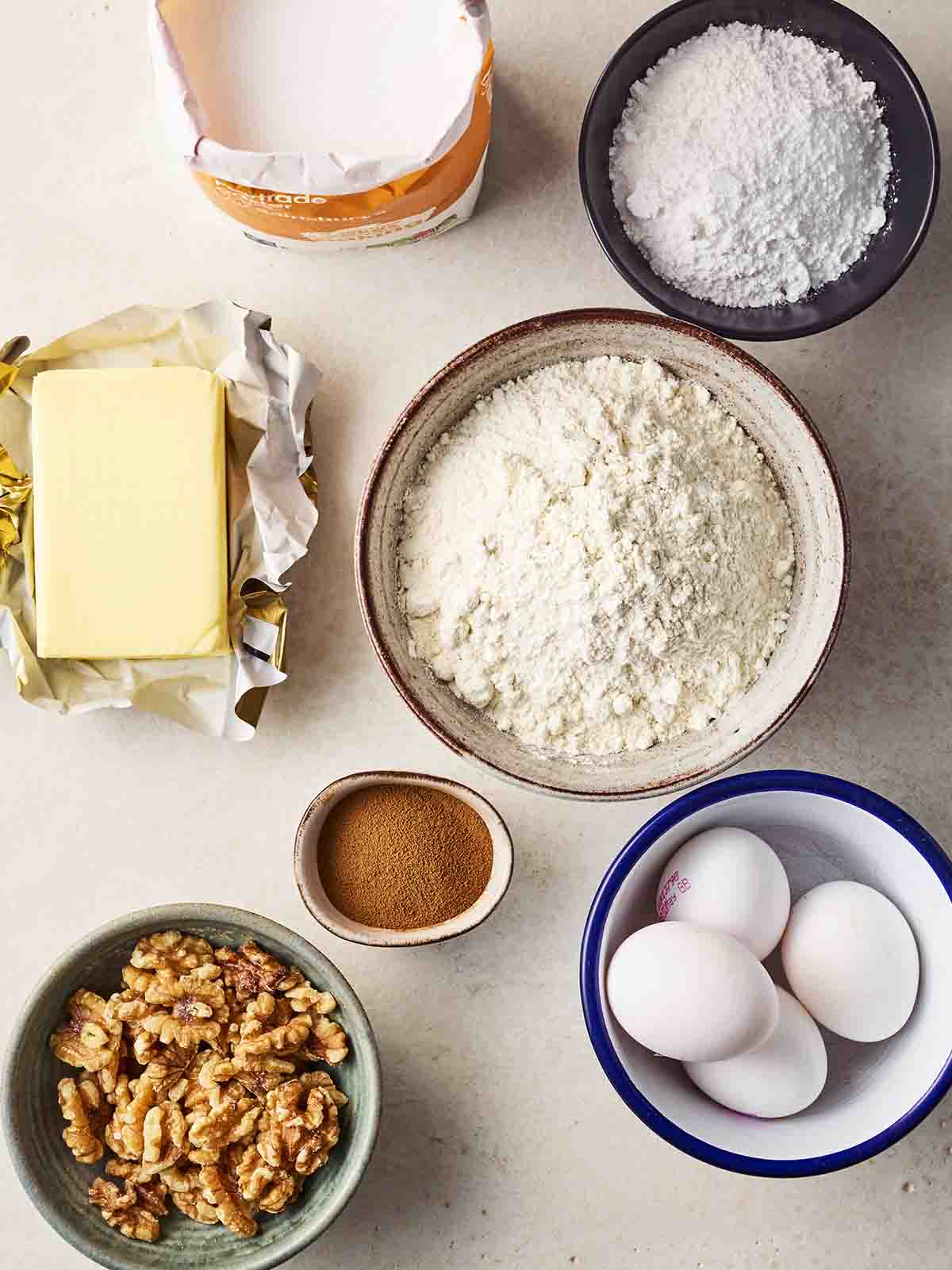 The ingredients for making a Coffee and Walnut Cake laid out on a white surface.