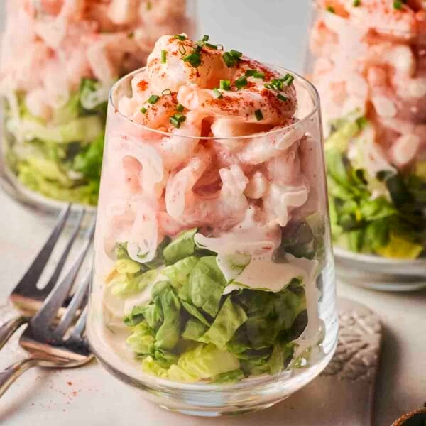 A close up of a classic Prawn Cocktail, with two more in the background, ready to eat.