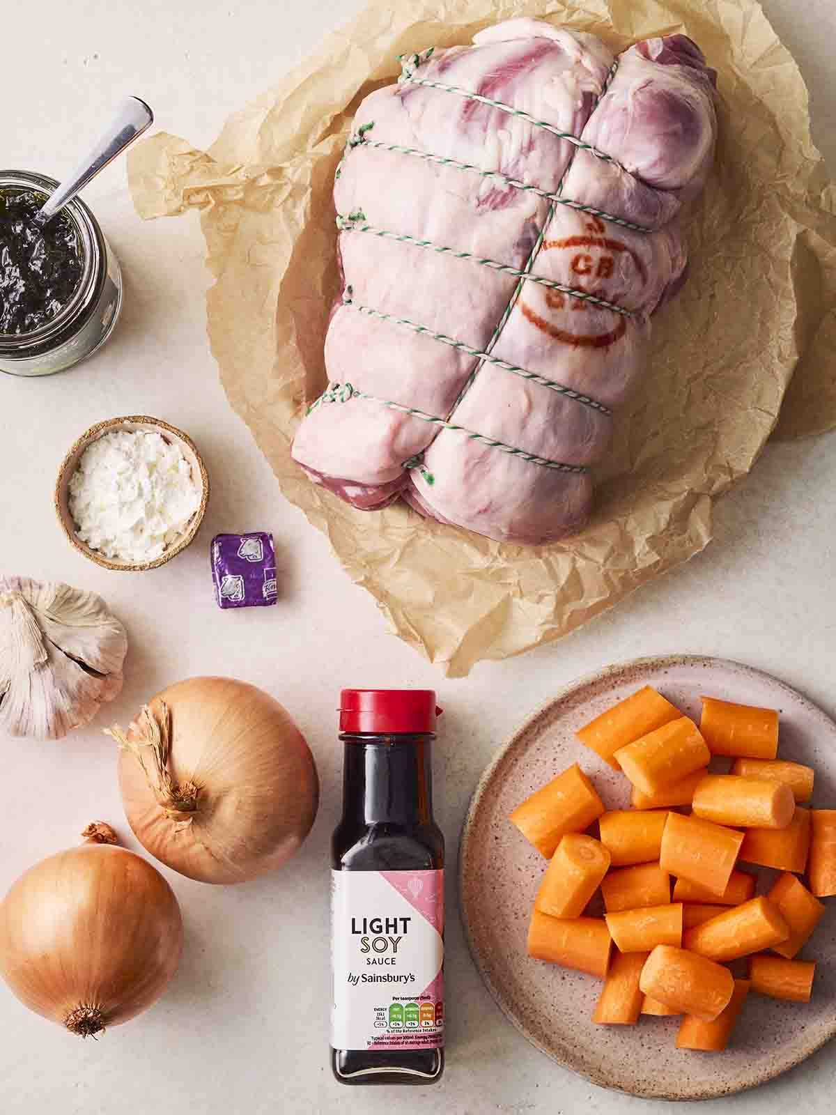 The raw ingredients for cooking Slow Cooker Leg of Lamb recipe laid out on a counter top.