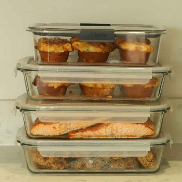 Sunday Setup Recipes for meal prep packed and piled into storage containers.