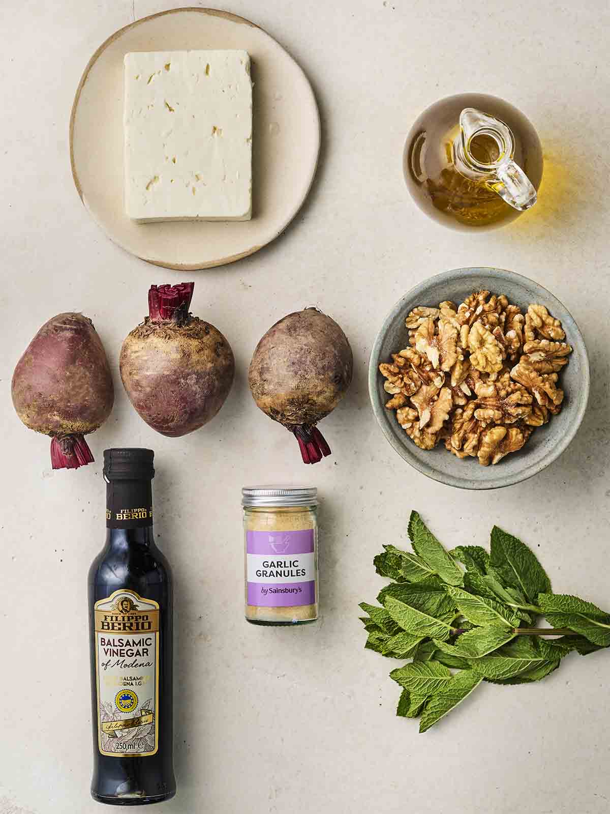 The ingredients for making a Beetroot Salad laid out on a white counter.