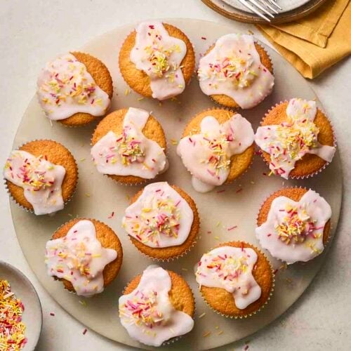 Lots of freshly baked fairy cakes, decorated and ready to eat.