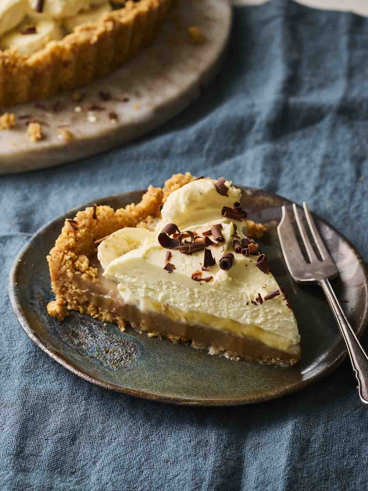 A slice of Banoffee Pie on a dessert plate with a cake fork at the side.