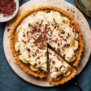A Banoffee Pie from above, ready to serve, with a slice already cut out.