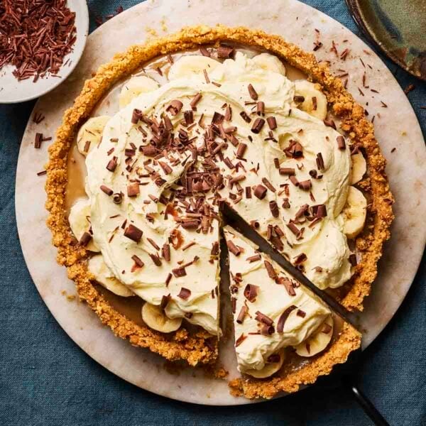 A Banoffee Pie from above, ready to serve, with a slice already cut out.