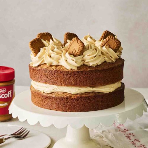 A Biscoff Cake on a cake stand.