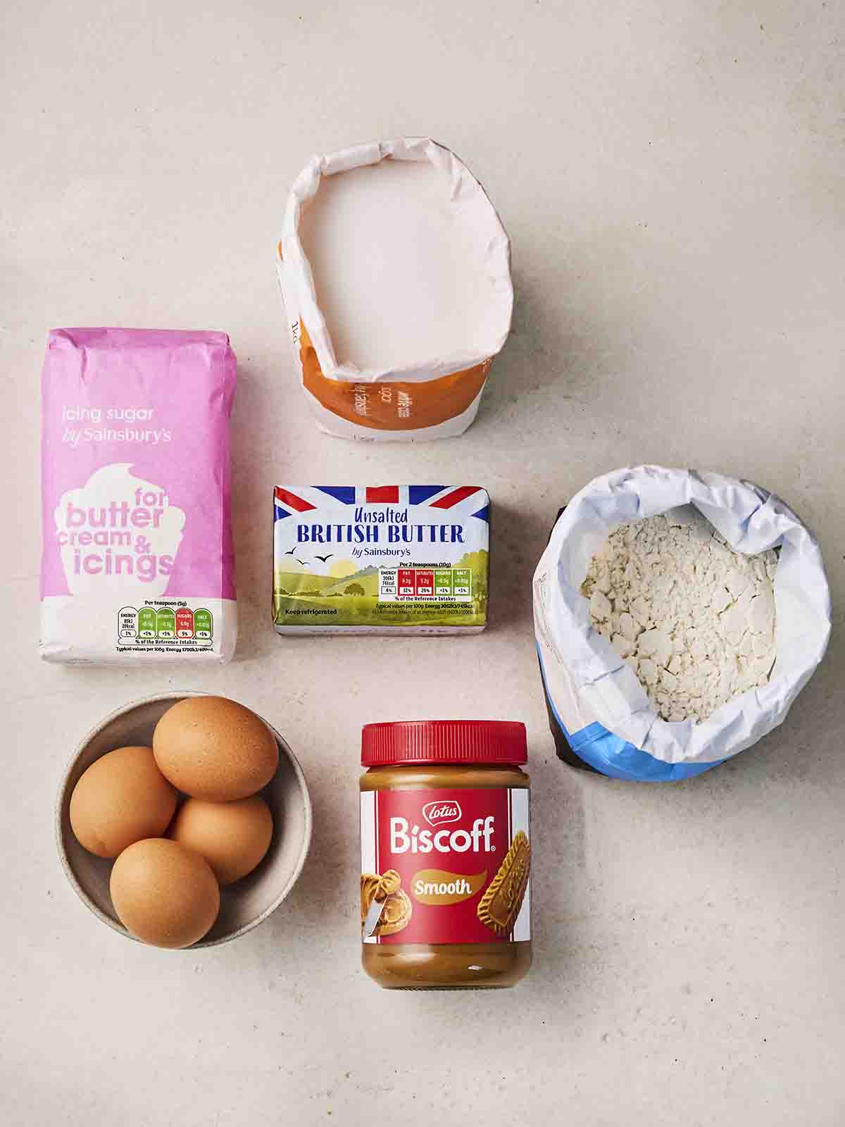 The ingredients for making Biscoff Cake laid out on a white counter.