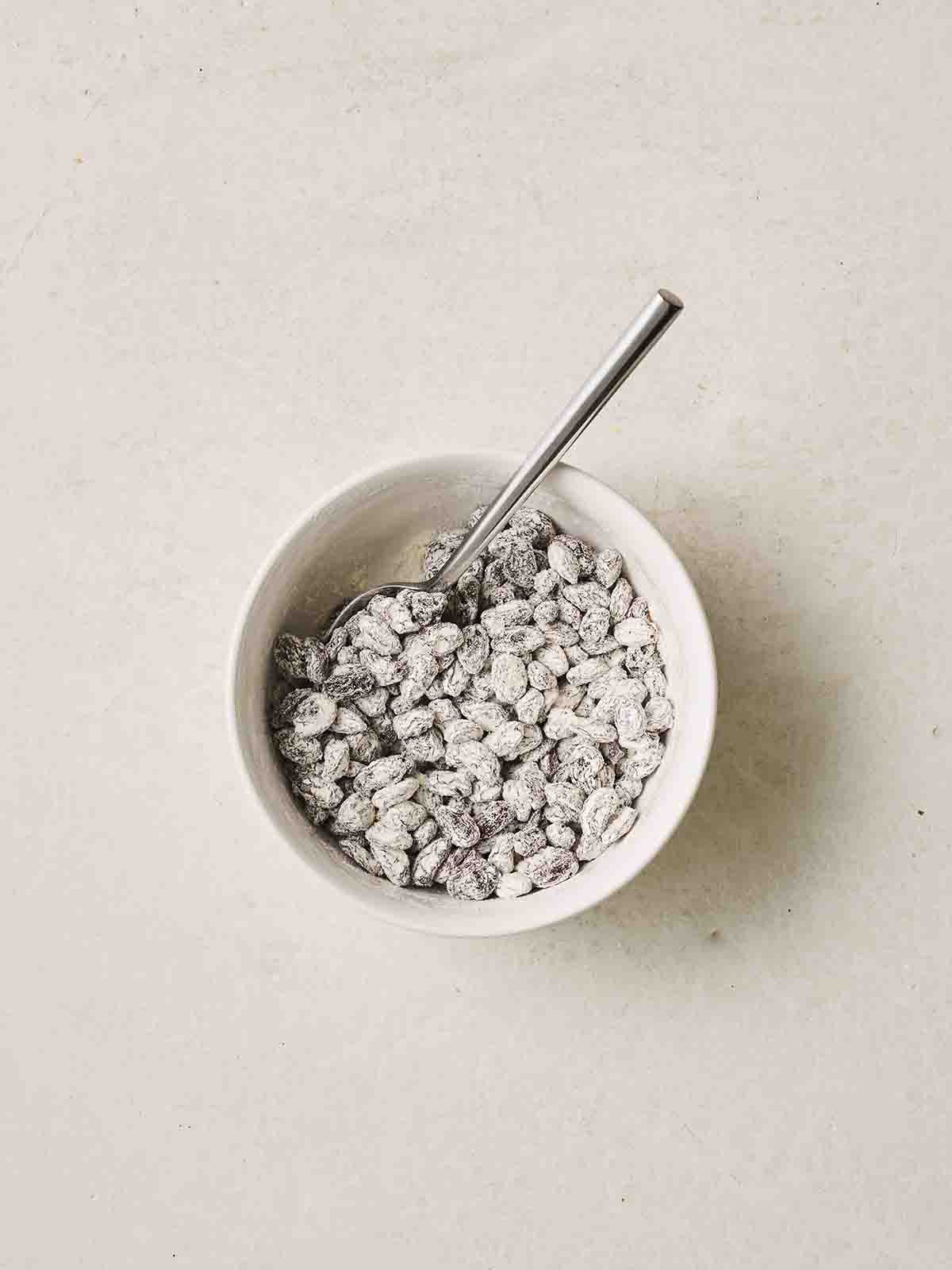 Raising in a small bowl being coated in flour.