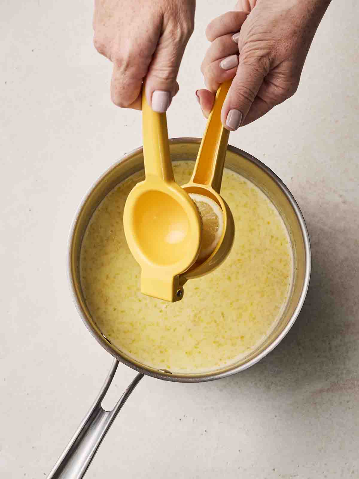 Lemon juice being added into a pan for step 3 in the recipe for Lemon Posset dessert.