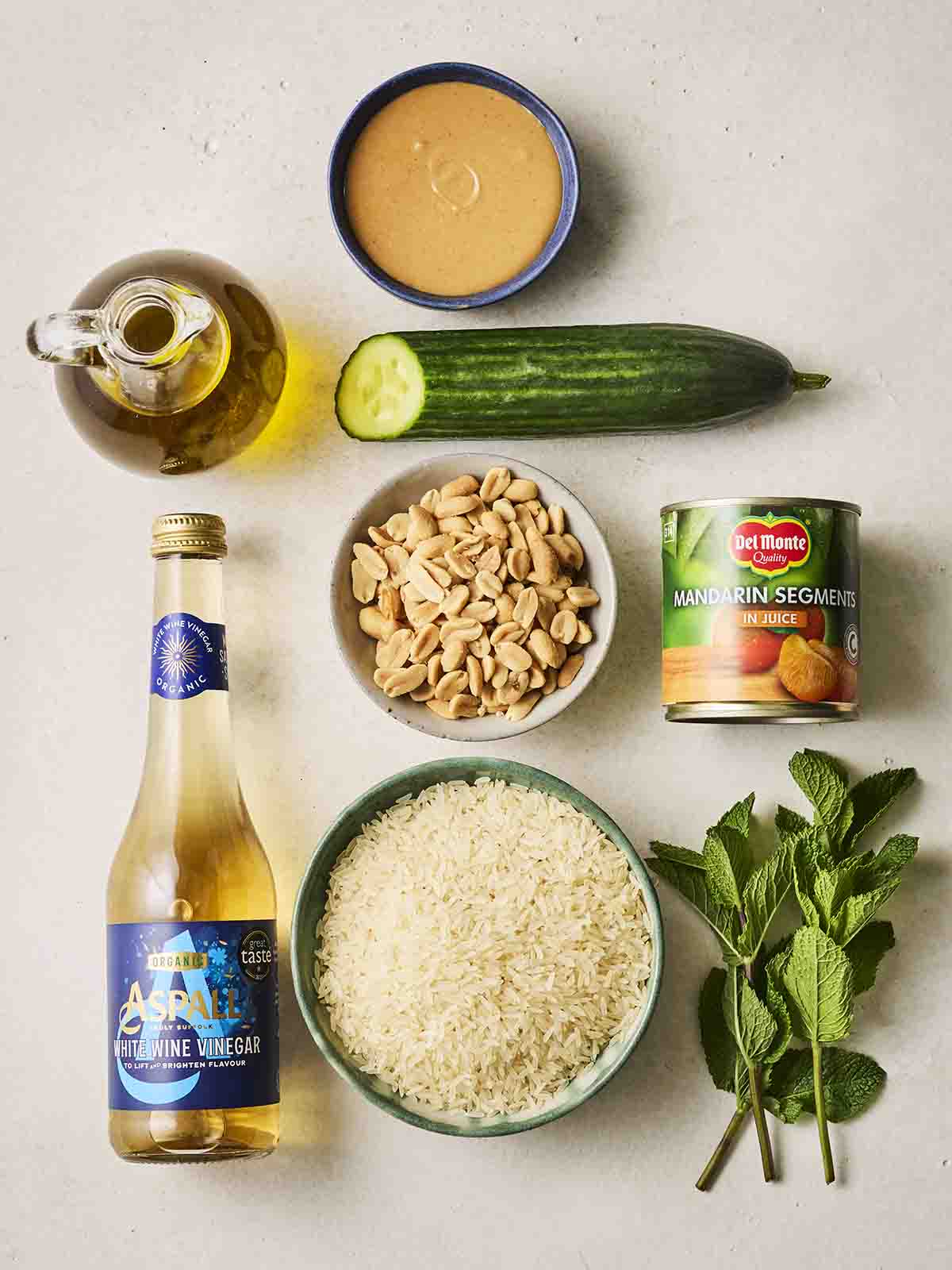 The ingredients for making a rice salad laid out on a counter.