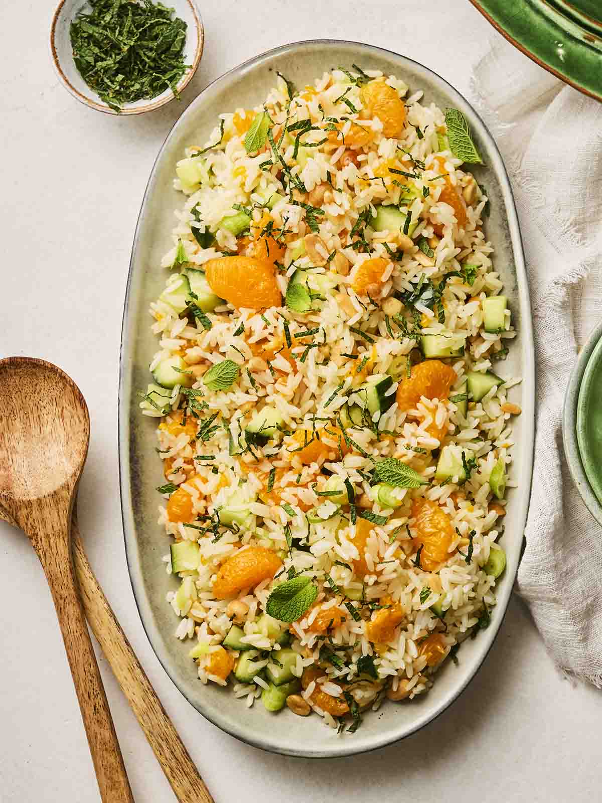 A colourful rice salad on a white platter.
