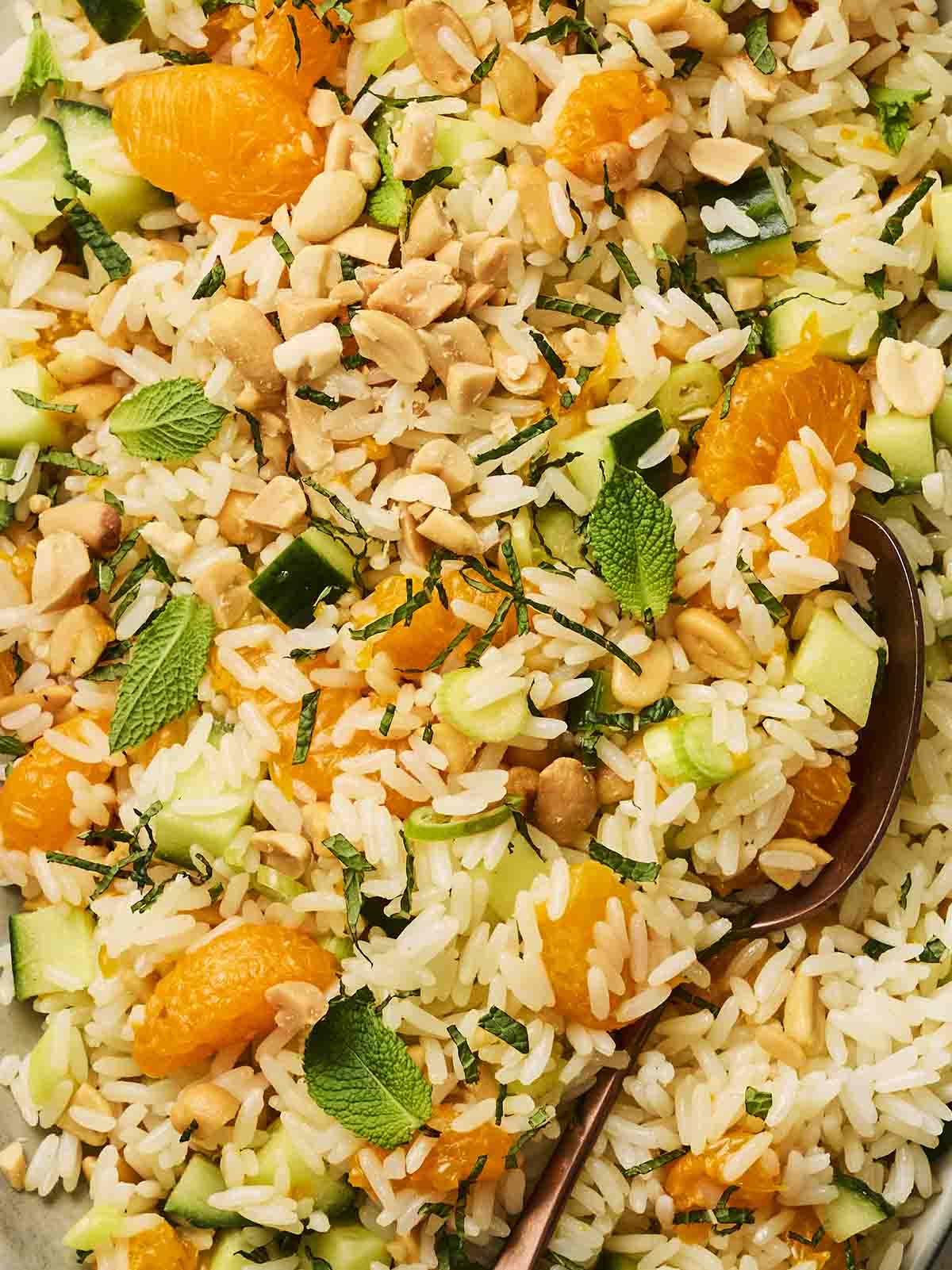 A close up of a colourful and easy rice salad, with mint leaves on top.