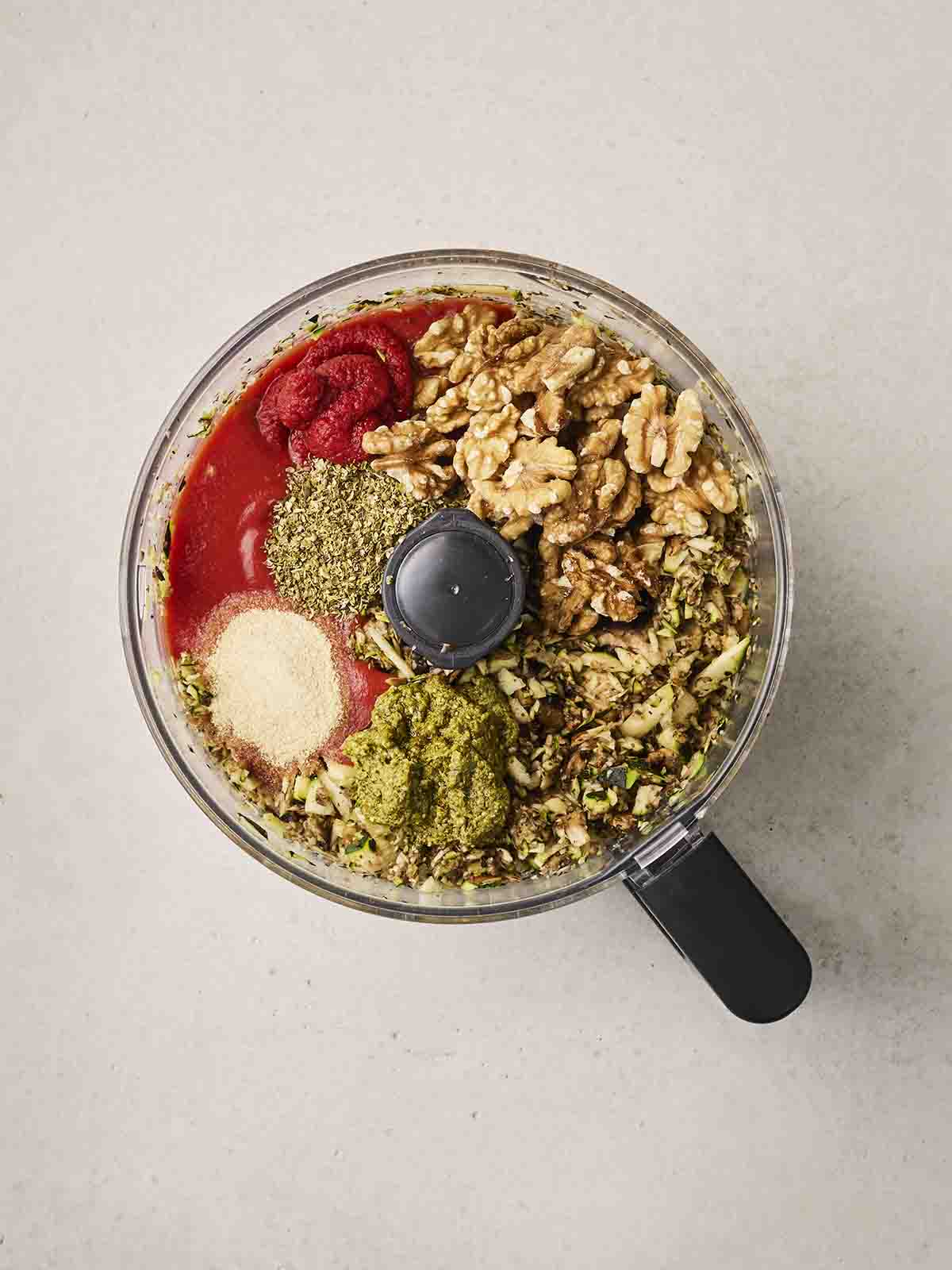 Vegetarian lasagne ingredients being blended together in a food processor.