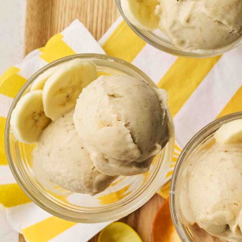 Three glass dessert bowls filled with Banana Nice Cream.