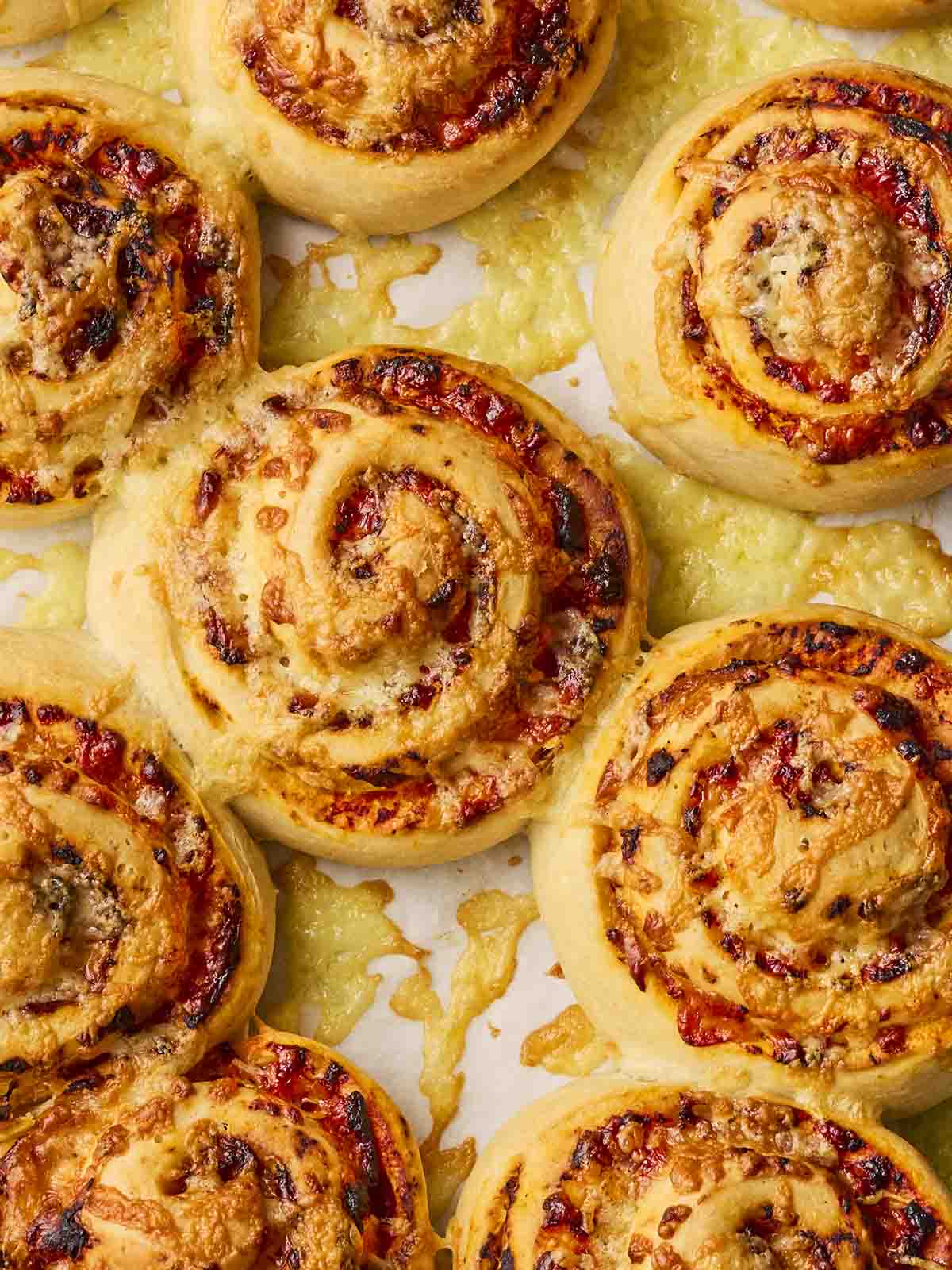 Freshly baked pastry swirls together on a baking tray.