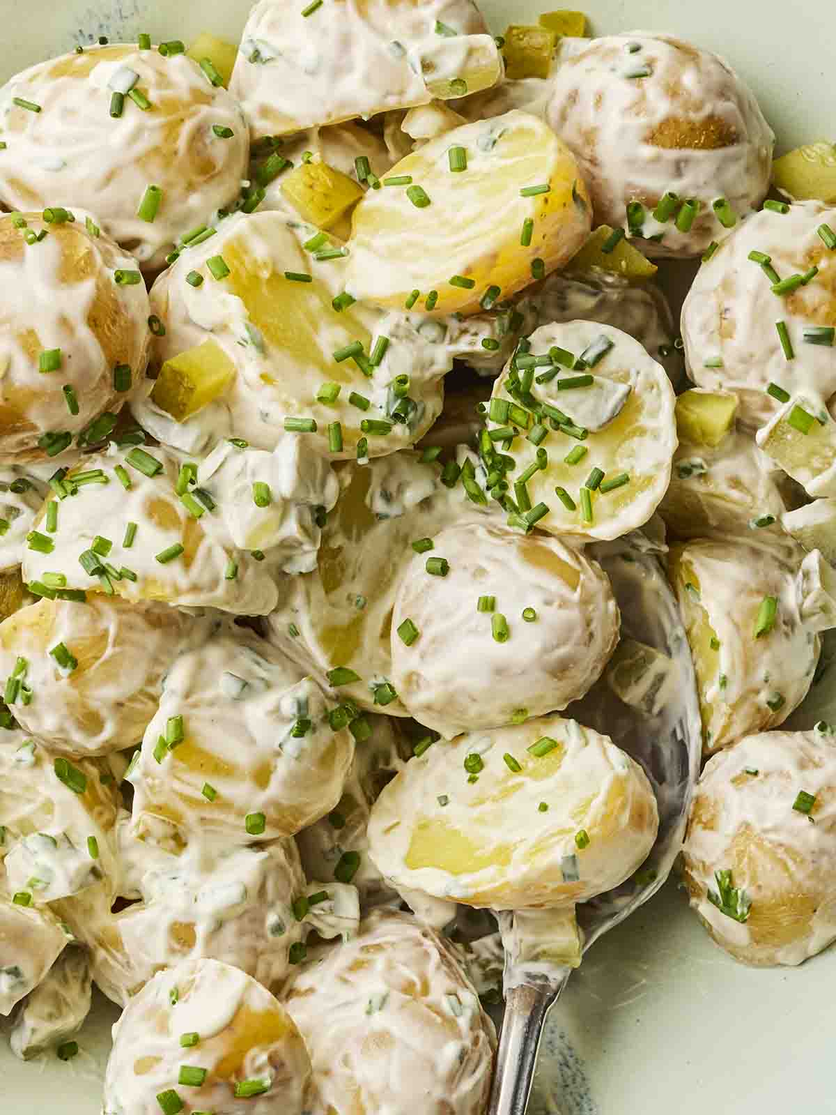 Potatoes mixed with mayonnaise and chives for a homemade Potato Salad.