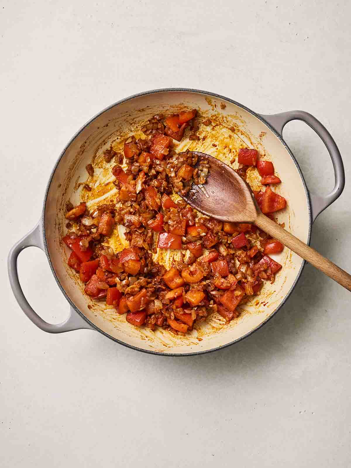 A pan filled with fried onion, peppers and spices.