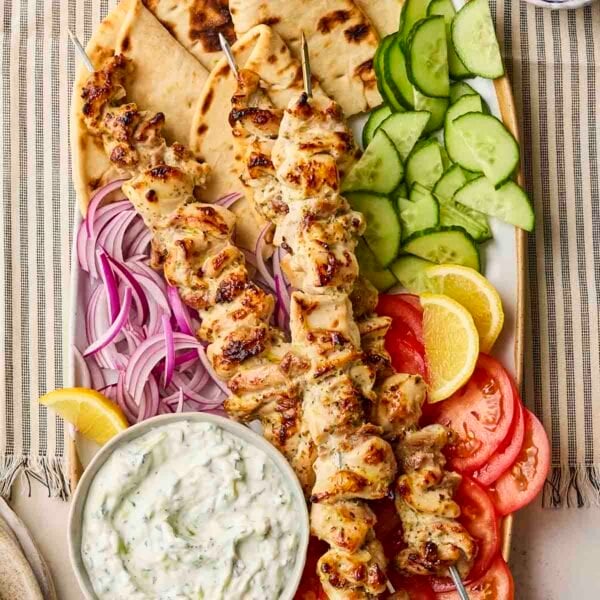 A platter of chicken souvlaki to share with flatbreads, salad and tzatziki.