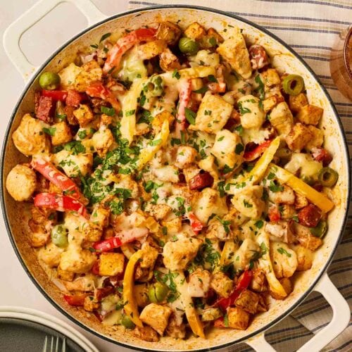 A pan of loaded potatoes with chicken and chorizo.