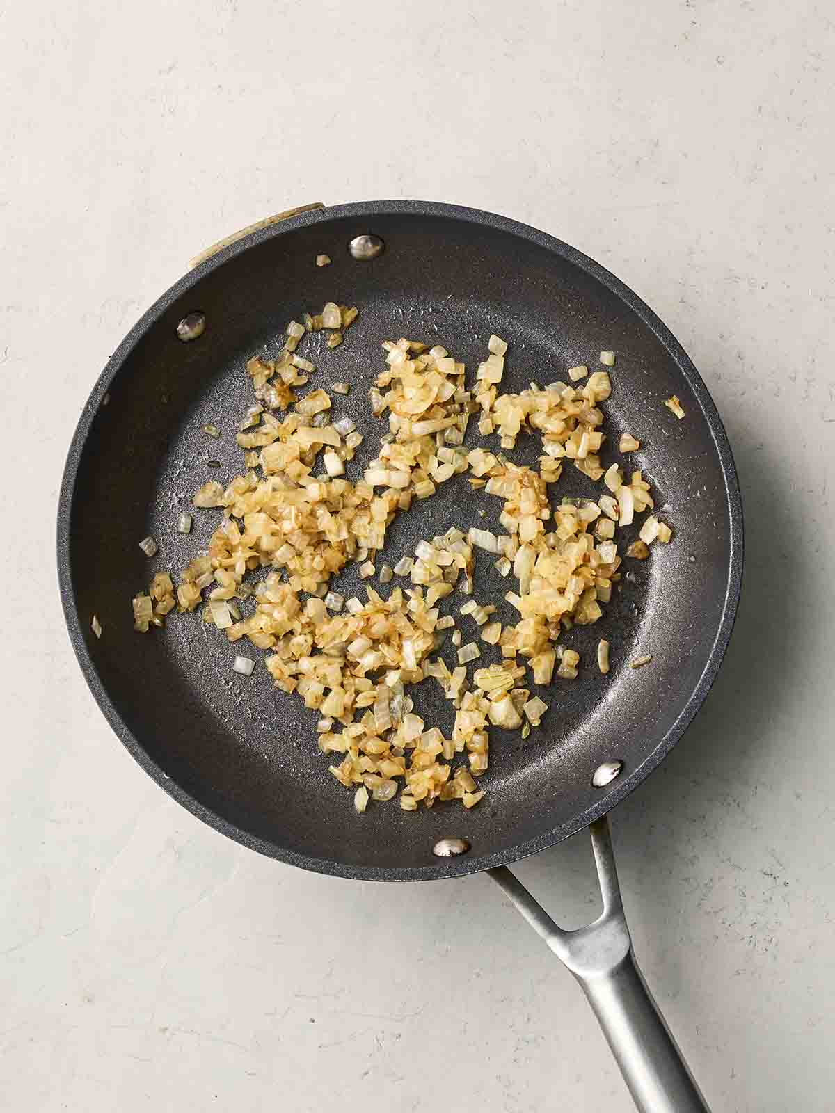 Onions frying in a pan.