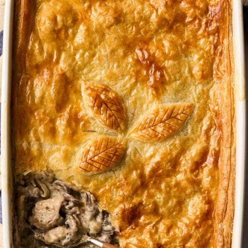 A chicken and mushroom pie in a white dish.