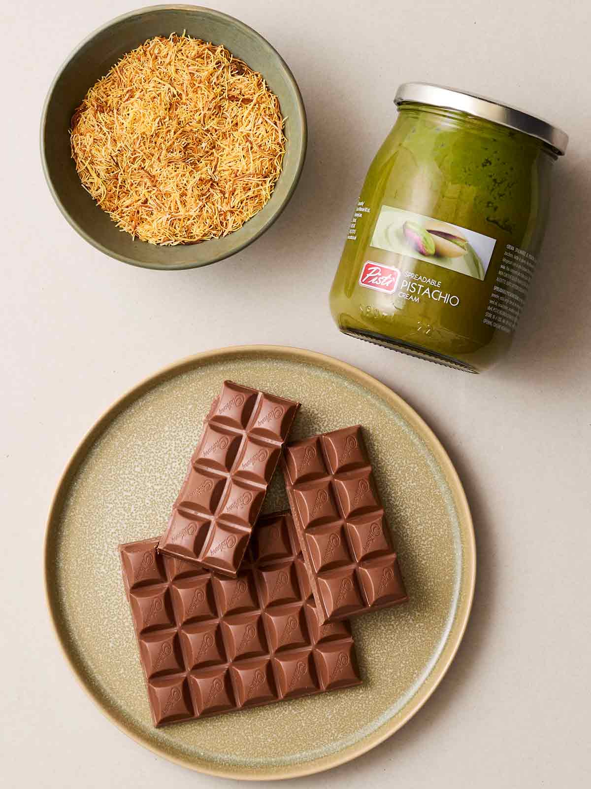 The ingredients for making Dubai Chocolate laid out on a white counter.